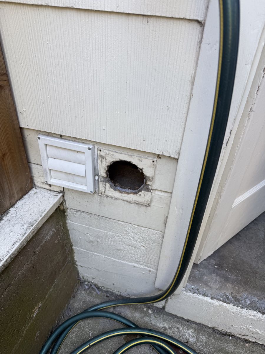 Before photo showing the original dryer vent area prior to new installation work