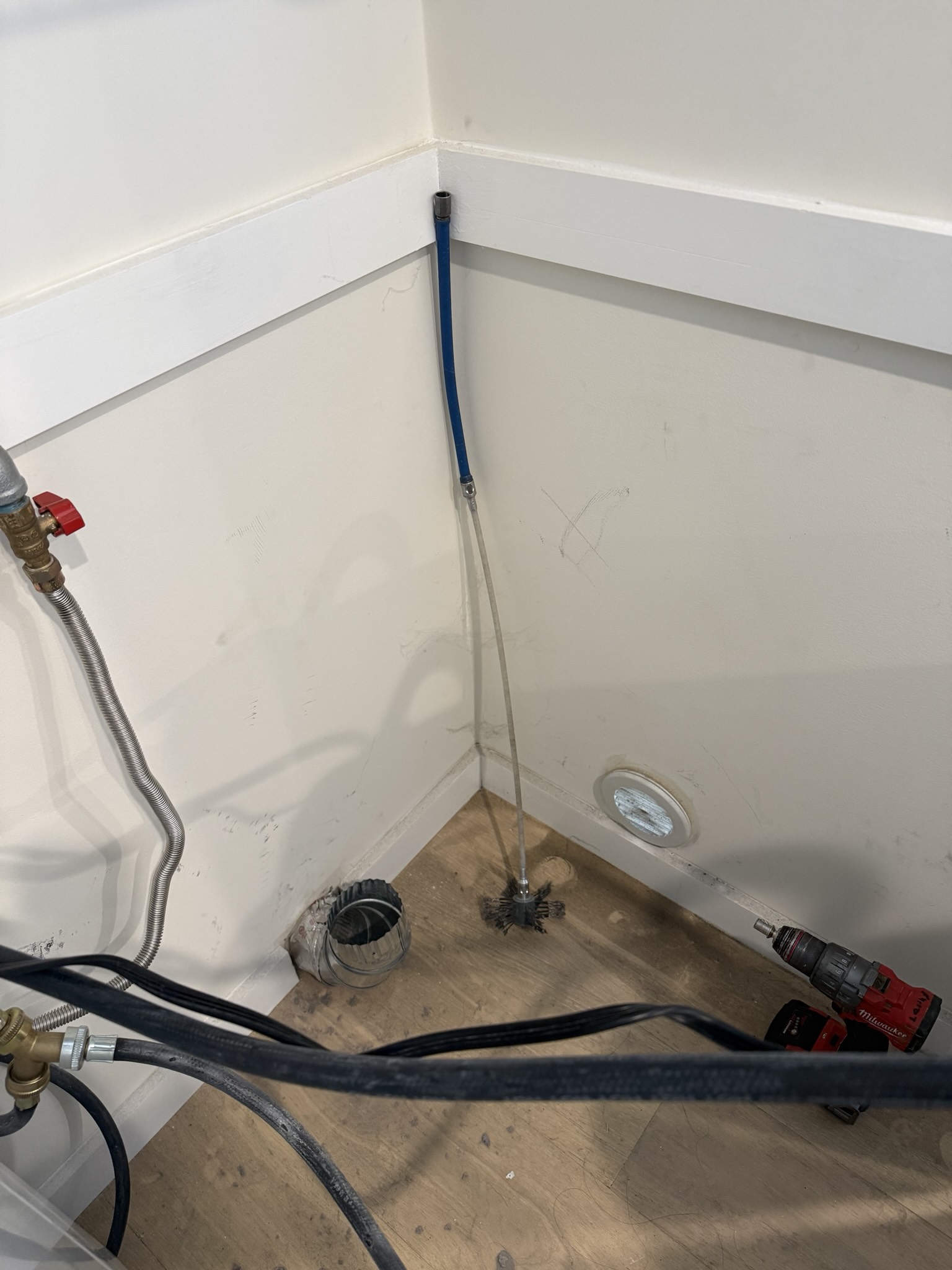 Interior view of dryer ductwork before cleaning showing accumulated lint buildup