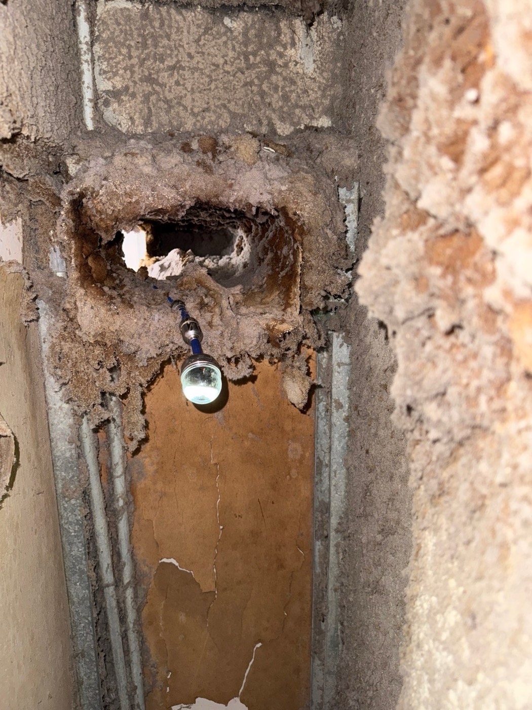 Massive lint accumulation inside a dryer vent duct around fittings and sensors in apartment building